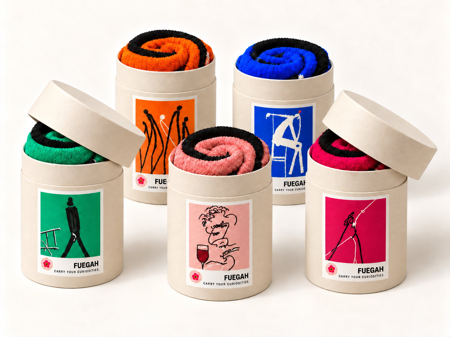 Five colorful FUEGAH socks rolled inside ivory cylindrical packaging